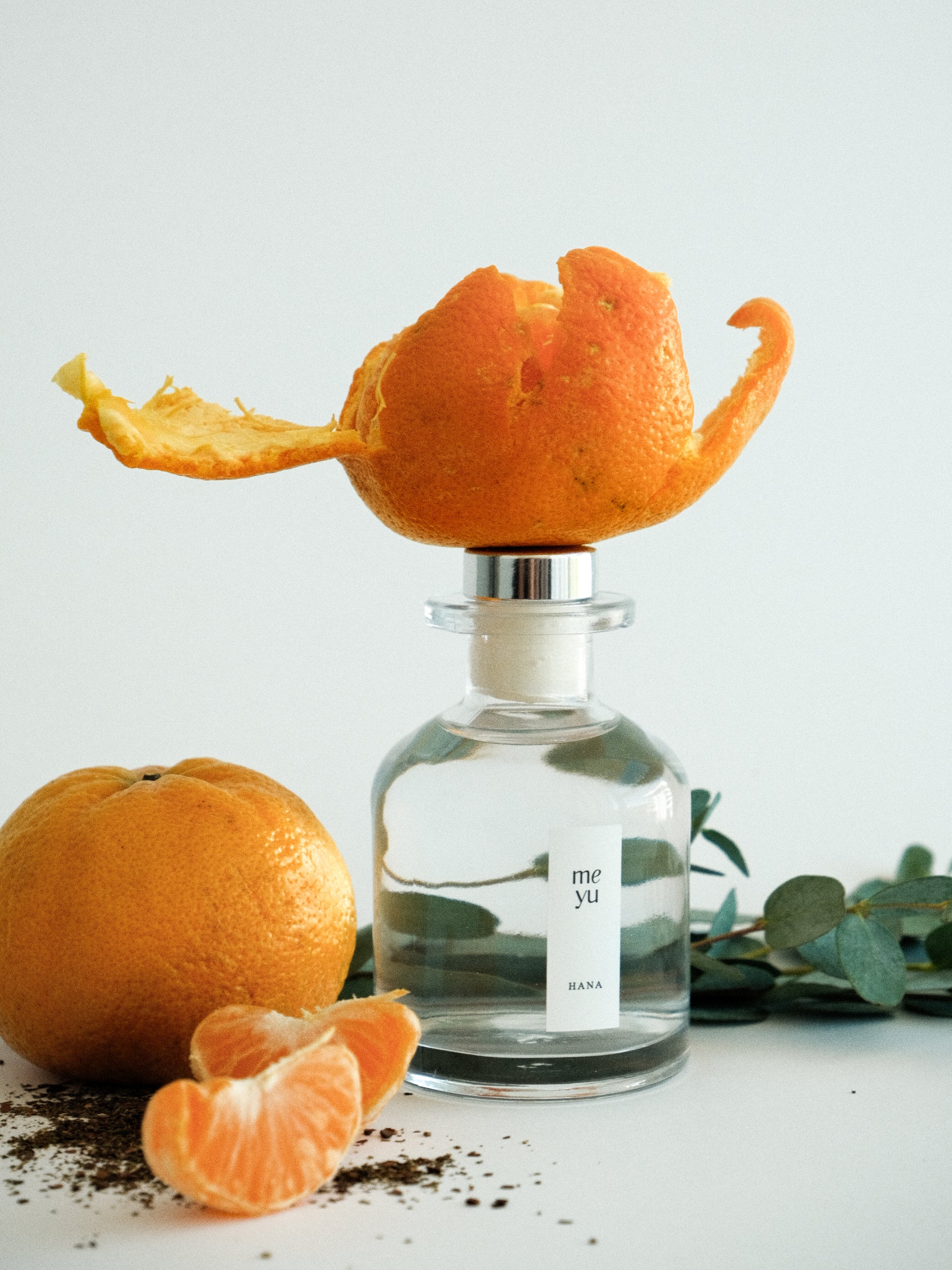 Hana reed diffuser on white background with eucalyptus and mandarin orange accents - calming home fragrance by Meyu Vancouver