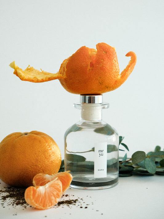 Hana reed diffuser on white background with eucalyptus and mandarin orange accents - calming home fragrance by Meyu Vancouver