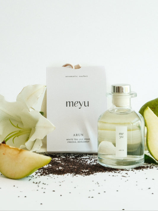 Arun gift set with reed diffuser and scented sachet on white background with pear, lily, and white tea accents - luxury home and car fragrance by Meyu Vancouver