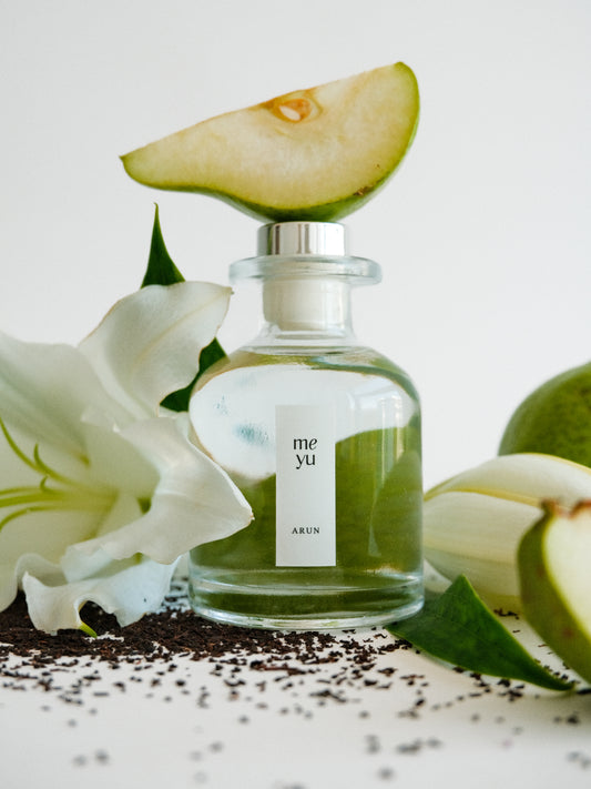 Arun reed diffuser on white background with pear, lily, and white tea accents - luxury home fragrance by Meyu Vancouver