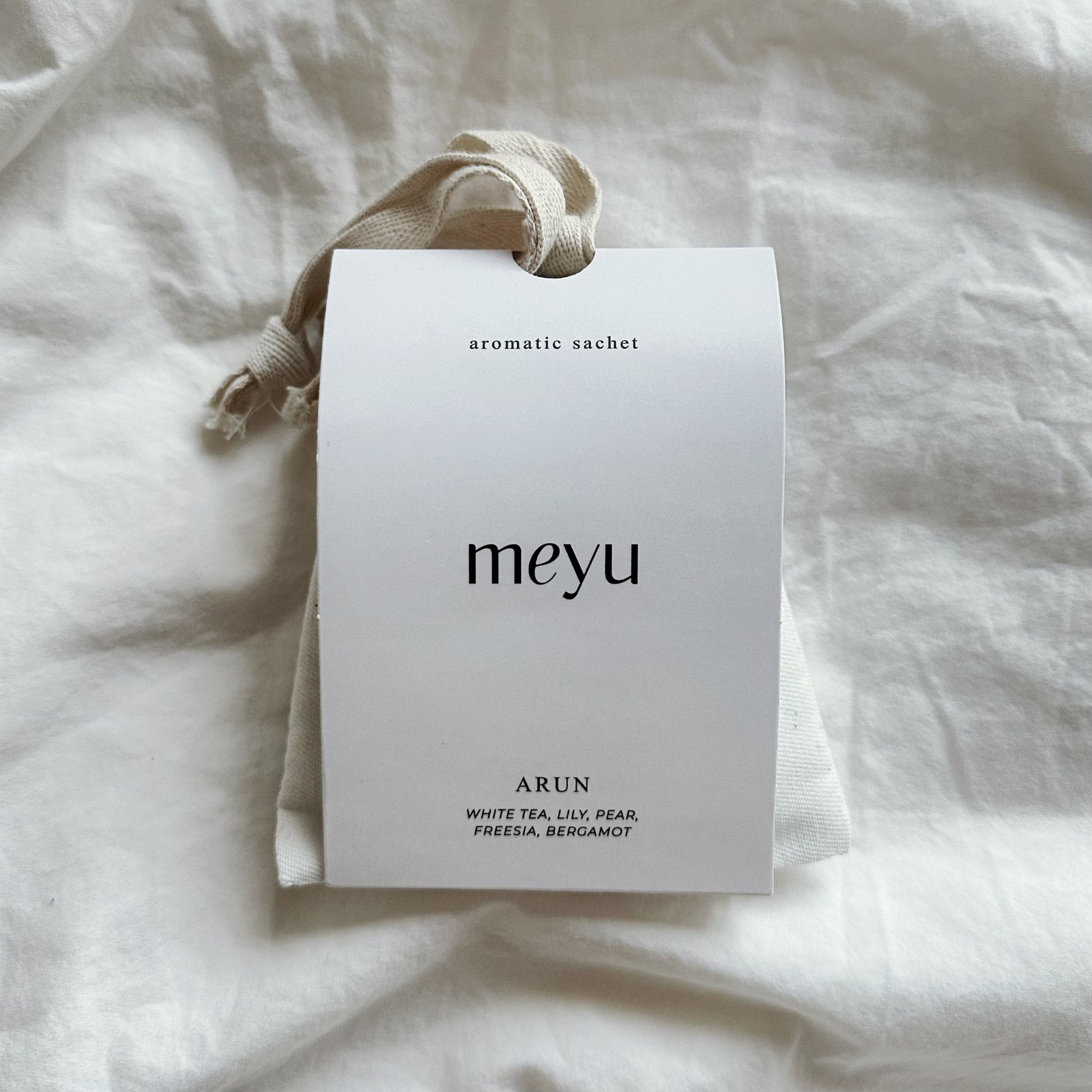 Arun white scented sachet on linen - luxury home fragrance with white tea and lily notes by Meyu Vancouver