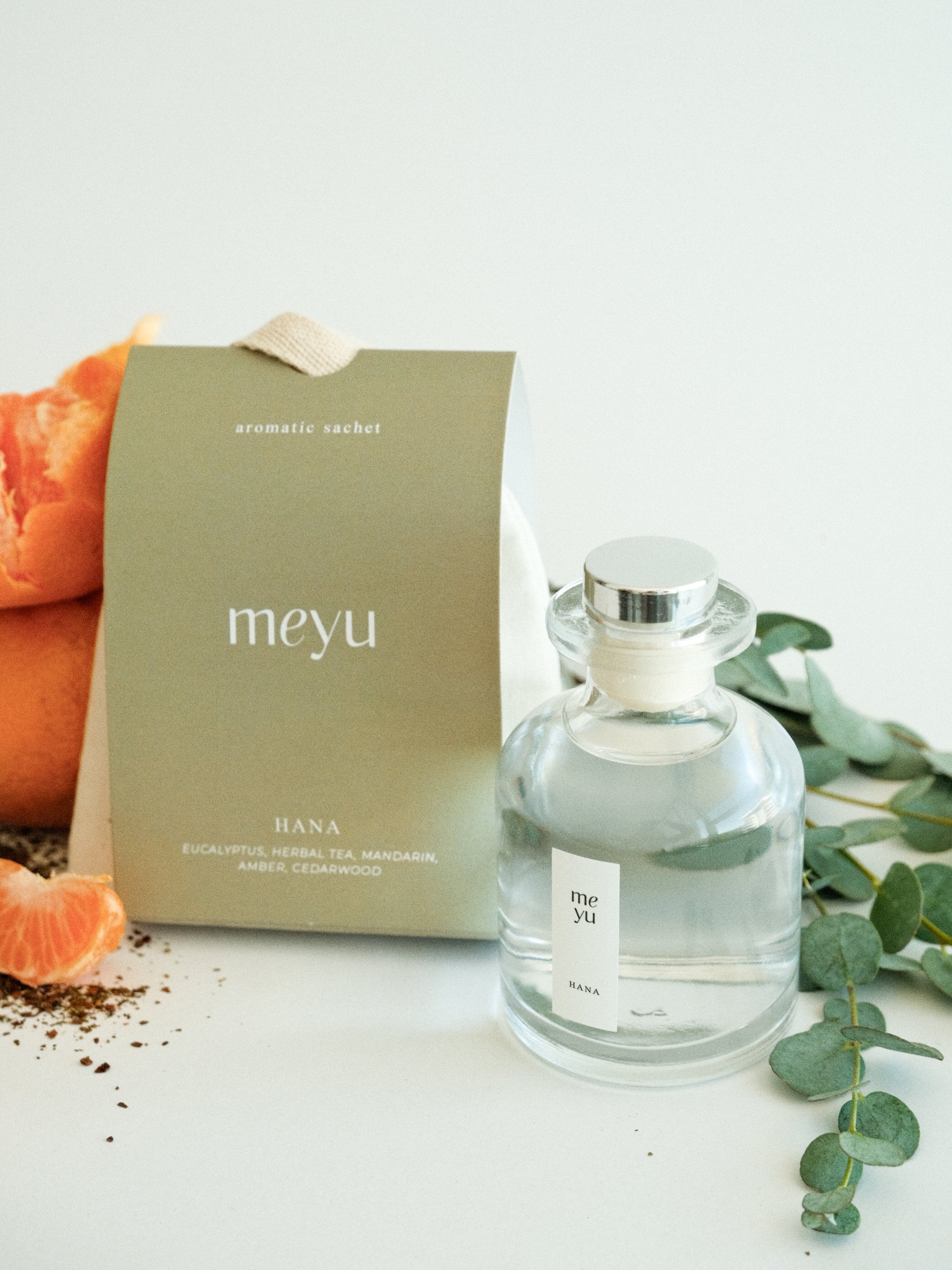 Hana gift set with reed diffuser and scented sachet on white background with eucalyptus and mandarin accents - calming home fragrance by Meyu Vancouver