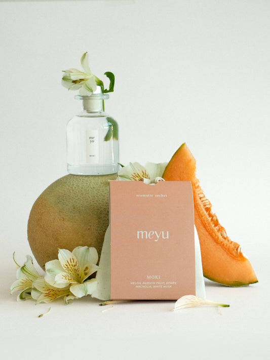Moki gift set with reed diffuser and scented sachet on white background with melon and magnolia accents - sweet fruity home fragrance by Meyu Vancouver